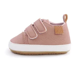Side view of pink faux leather baby walking shoes with dual velcro straps