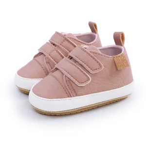 Close-up of pink baby pre-walker shoes with double hook-and-loop straps