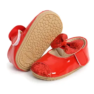 Detailed view of red Christmas baby princess shoes with glitter bow and anti-slip sole