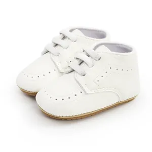 Detailed side view of white soft sole infant walking shoes with classic brogue detailing