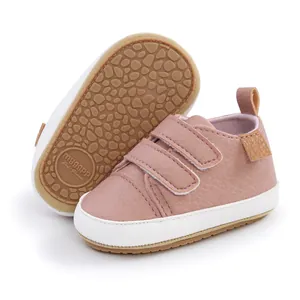 Detailed macro view of pink baby walking shoes featuring a non-slip textured rubber sole