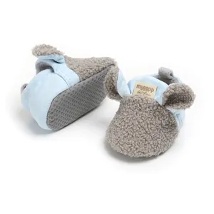 Close-up of cute blue baby booties featuring grey sherpa fleece ears and non-slip soles