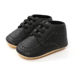 Front view of black infant walking shoes showing pebble texture and brogue details