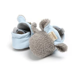 Close-up of cute blue baby pre-walker shoe with soft grey sheep wool texture detail.