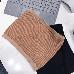 Detailed view of seamless knitted abdominal support waist belts in nude and black colors.