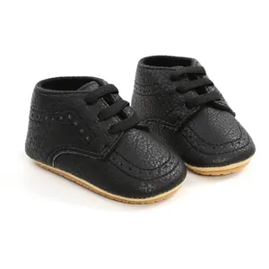 Close-up of black PU leather baby walking shoes with soft soles and laces