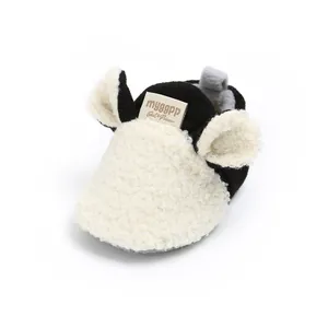 Close-up of fluffy sherpa baby walker shoe with cute ear design and brand label
