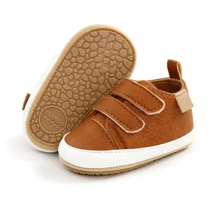 Detail view of brown baby walking shoes with anti-slip rubber soles and hook-and-loop straps.