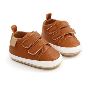 Brown leather-like baby walking sneakers with white soles and double velcro straps