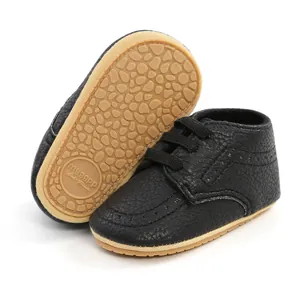 Detailed view of black PU leather baby shoes with non-slip soft rubber soles