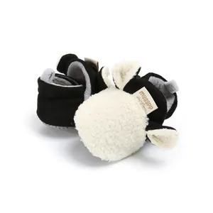 Detail view of cute cartoon sheep baby winter walking shoes with warm fleece lining