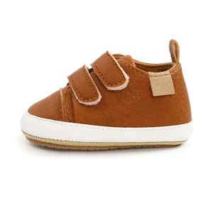 Detailed side view of brown leather baby walking shoes with double velcro straps