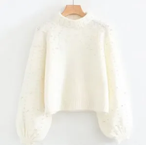 Elegant white crew neck knit pullover sweater with pearl embellishments on sleeves and yoke.