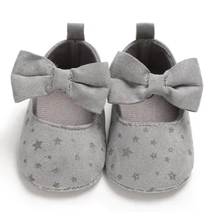 Detailansicht grauer Baby-Prinzessinnenschuhe mit Schleife und silbernem Sternmuster