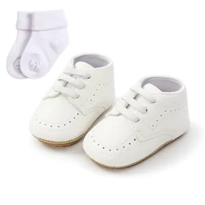 Detailed view of white baby soft sole walking shoes with matching cotton socks