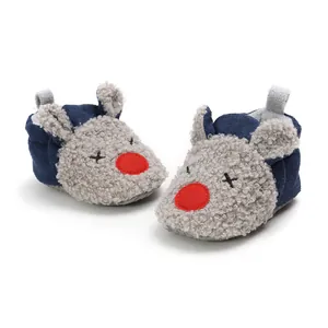 Warm cartoon baby winter booties with soft soles and cute reindeer design details.