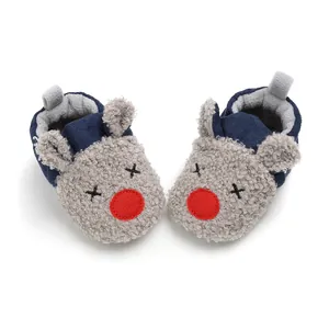 Top view detail of reindeer cartoon baby winter shoes with grey fluffy texture and red nose