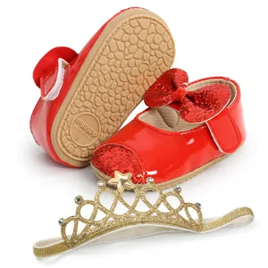 Macro detail of red sequin baby princess shoes with matching gold crown headband