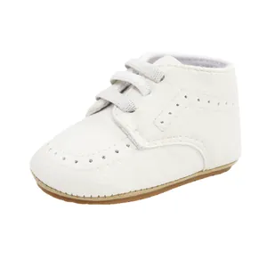 Classic white soft sole leather baby walking shoes for infants 0-12 months with lace-up detail