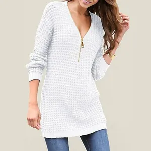 Detailed view of women's white V-neck knit sweater featuring a stylish gold zipper.