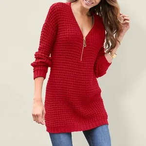 Detail view of red v-neck knitted sweater featuring a gold zipper and waffle texture