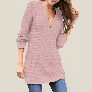 Close-up showing the textured knit and gold zipper detail of this pink V-neck sweater