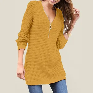 Detail of yellow waffle knit sweater featuring V-neckline with gold zipper closure