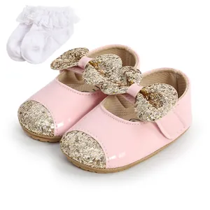 Pink baby princess shoes featuring a glitter bow and matching white lace socks set.