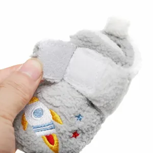 Detail van zachte baby winterschoen met raketborduursel en handige klittenbandsluiting