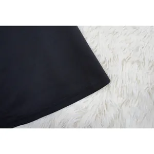 Macro detail shot showing the hem stitching and texture of the black knitted fabric.