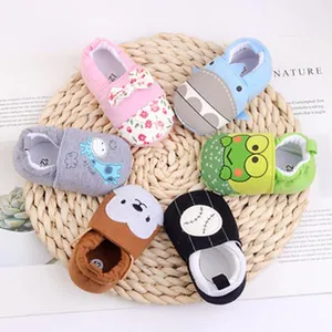 Variety of cute cartoon-patterned breathable mesh baby pre-walker shoes on a mat.