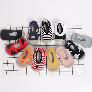 Detail view showing a variety of colorful breathable non-slip baby sock shoes on a grid.