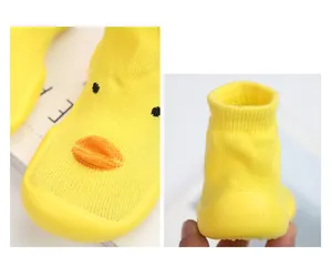 Detailed macro view of yellow duck baby walking shoes with soft non-slip rubber sole