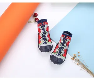Close-up of baby anti-slip sock shoes with colorful knitted pattern and rubber sole