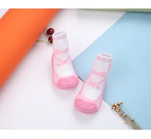Detail view of pink ballet-style baby sock shoes with non-slip rubber soles for toddlers