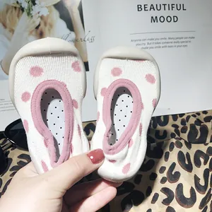 Detail view of pink polka dot baby sock shoes with flexible anti-slip soft rubber soles