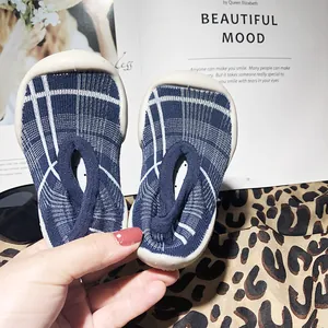 Close-up view of blue plaid toddler walking shoes with anti-slip soft rubber soles
