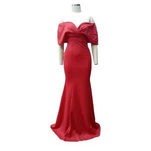 Detailed view of an elegant red off-the-shoulder mermaid evening dress on a mannequin.