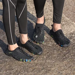 Quick-dry outdoor water shoes for men and women on a rocky beach