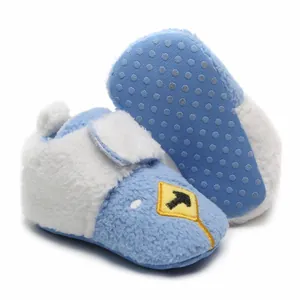 Detailweergave van blauwe pluizige babyloopschoenen met antislipzolen en borduurwerk