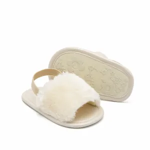 Close-up of baby fuzzy sandals with floral non-slip sole and elastic heel strap
