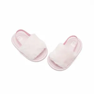 Soft pink fuzzy baby sandals for infants 0-6 months on a clean white background.