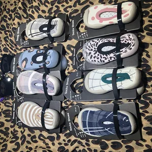 Detail view of various patterned baby sock shoes with soft anti-slip rubber soles