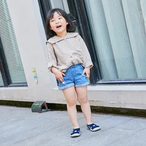 Toddler breathable navy blue sock shoes with white dots, worn by a child outdoors