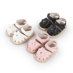 Soft-sole baby walking sandals with flower decor available in white, black, and pink.
