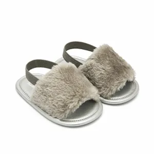 Detailed view of grey fuzzy faux fur baby sandals with silver sole and elastic strap
