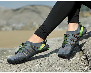 Detailed view of quick-dry outdoor water shoes on a rocky beach for diving and swimming