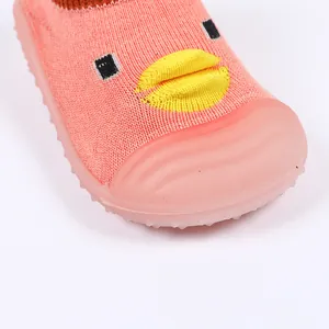 Close-up of pink baby walker sock shoe featuring a cute duck face and durable rubber sole