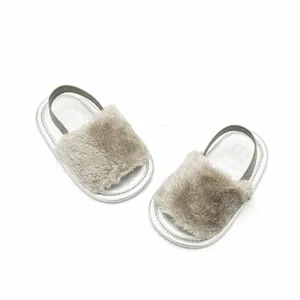 Detail view of fluffy gray baby sandals with silver metallic soles