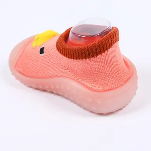 Detail view of pink baby sock shoes with soft non-slip sole and cute duck design